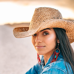 Dark haired model wearing a straw cowboy hat